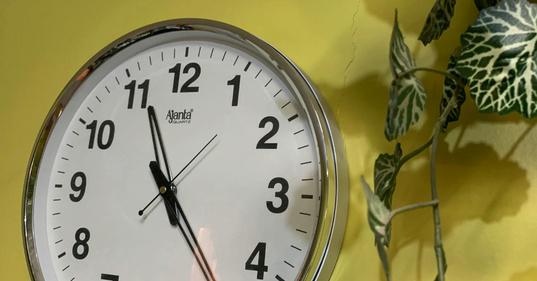 Analog clock against a yellow wall Photo Source // Unsplash: Mohammad Al Dossary